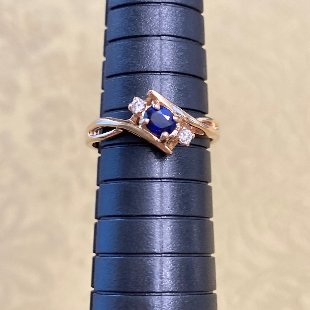 COPY - This is a pretty, genuine sapphire and diamond ring set in 10K gold.